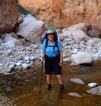 woman hiking in creek