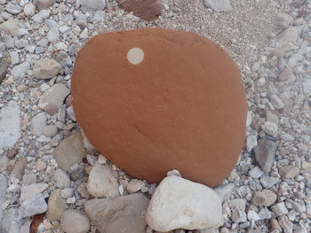 red rock with a perfect circle on it