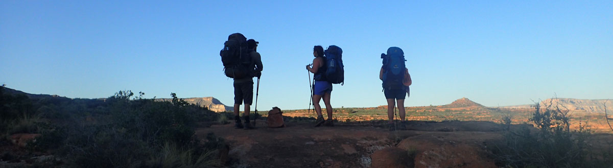 3 hikers in shadow