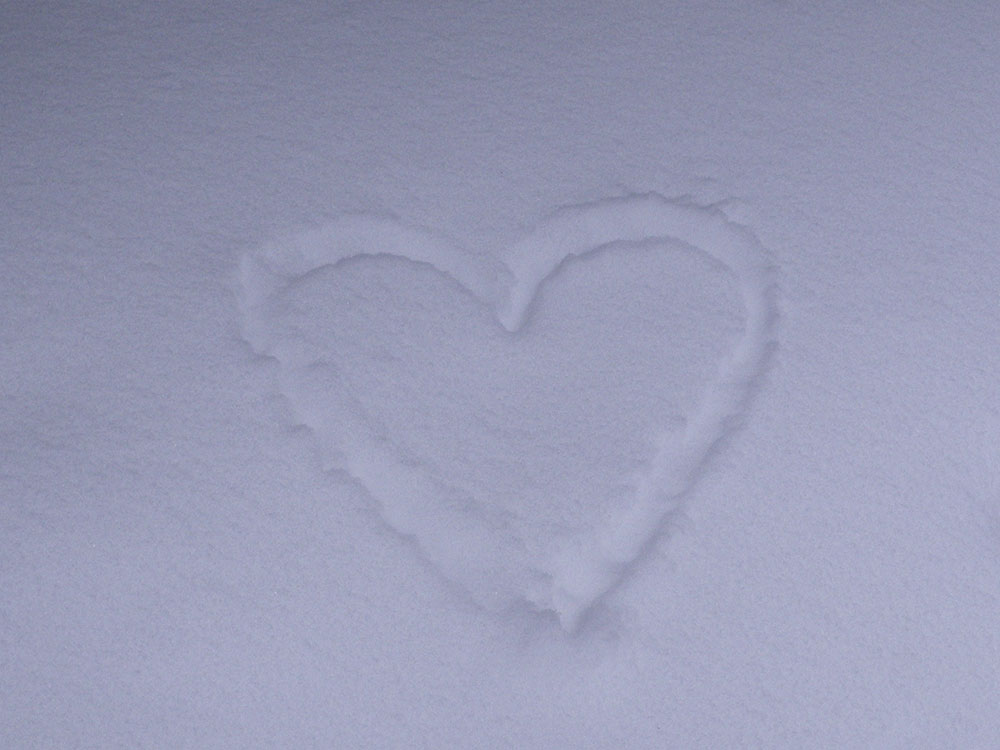 heart drawn in the snow with a finger