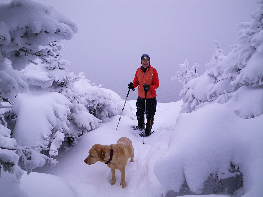 Pat and Dejah hiker and lab on ledge in winter
