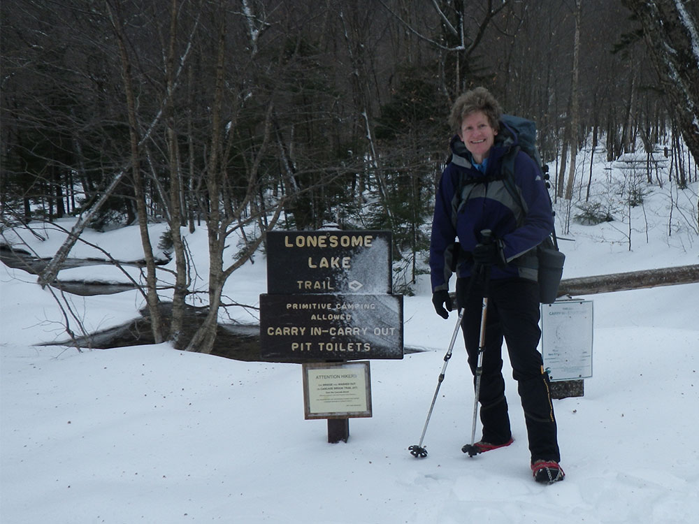 hiker at trailhead sign