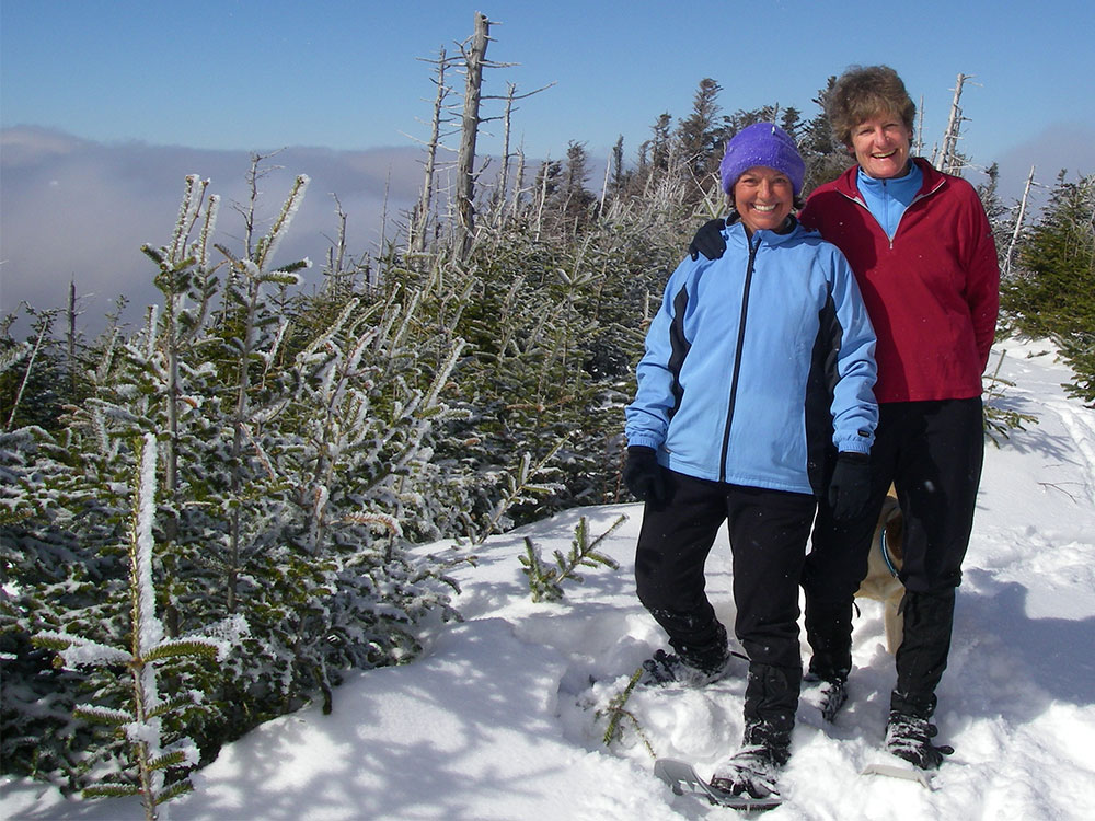 two hikers on the summit of Mt Field in the White Mountains