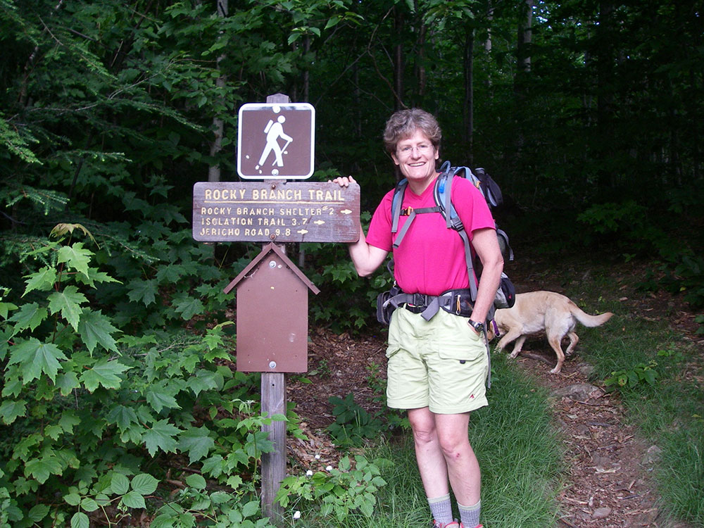 hiker at trailhead sign