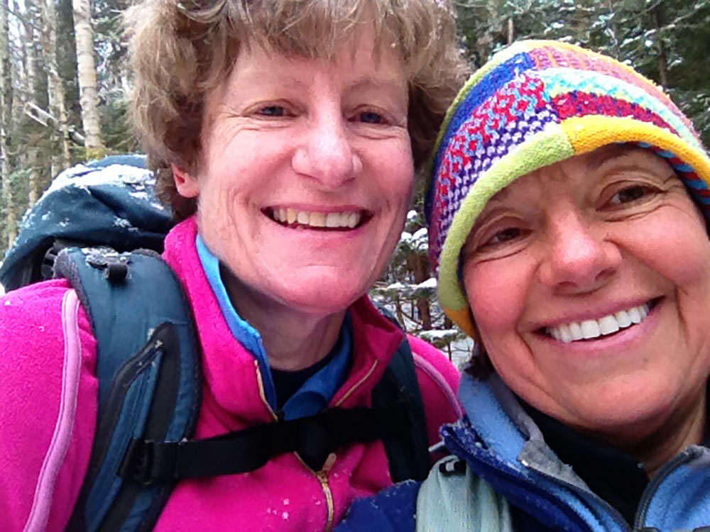 two hikers taking a selfie at the summit of Mt. Willey