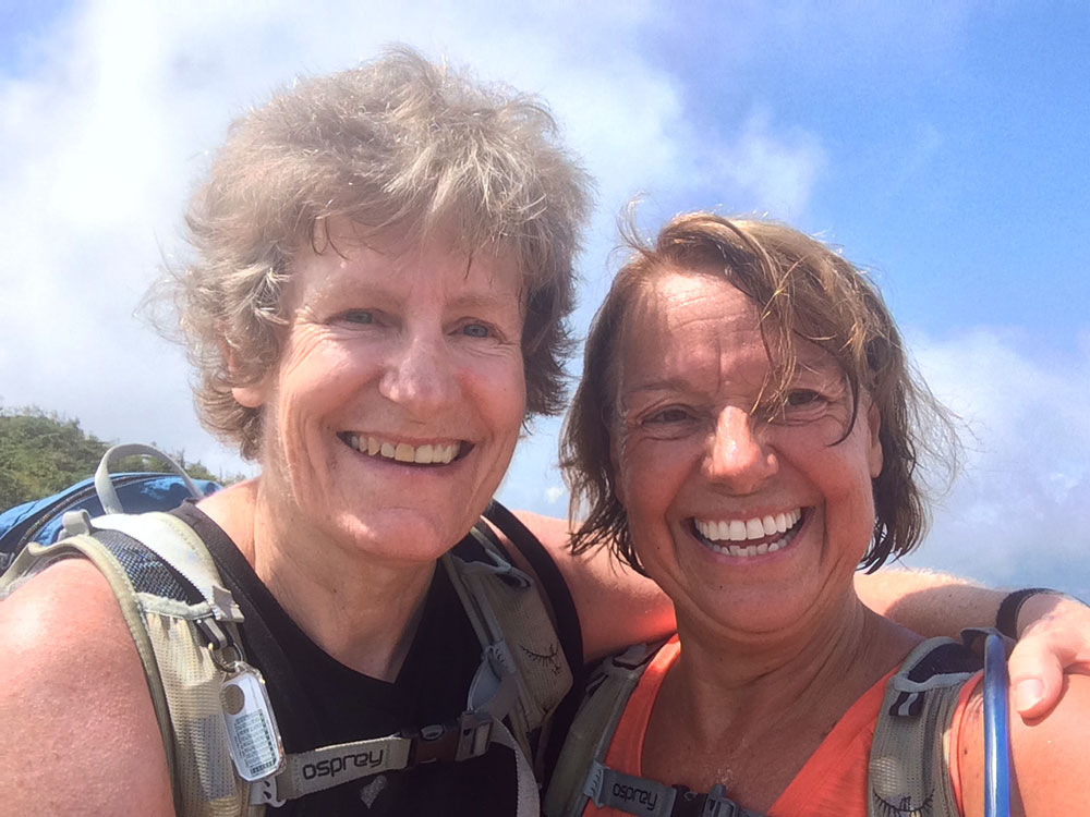 two hikers taking a selfie above tree line