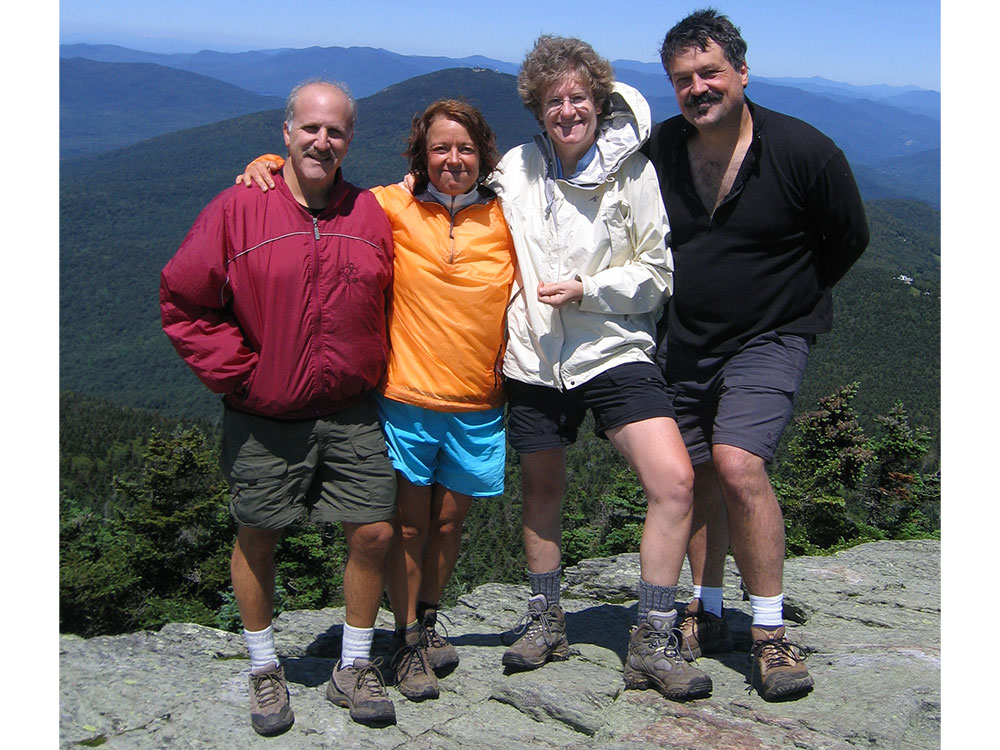 At the summit hikers on the summit of Killington