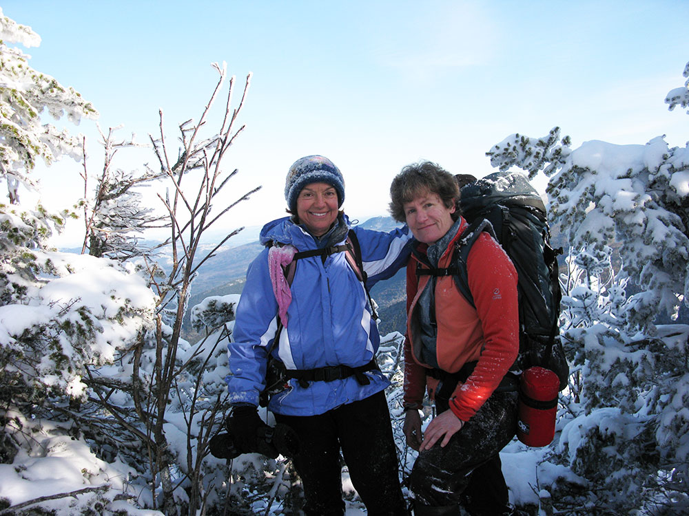 two hikers at the summit of North Tripyramid