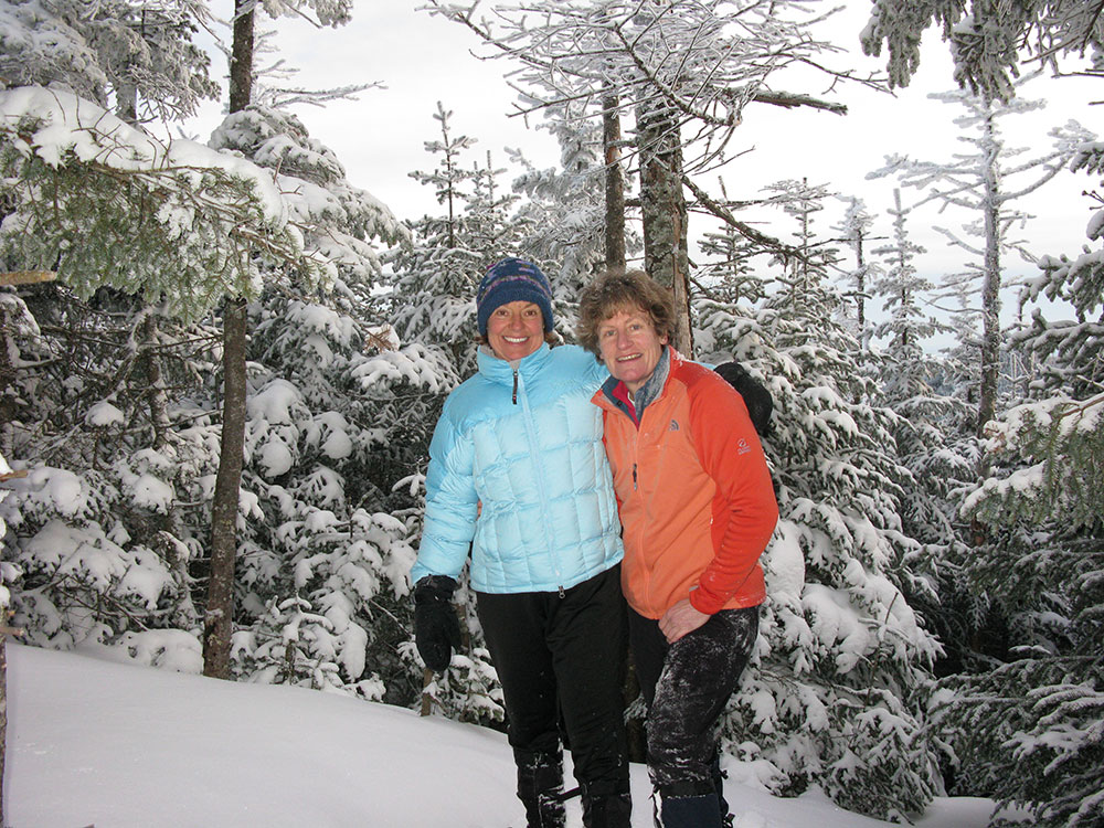 two hikers on the summit of Middle Tripyramid in winter