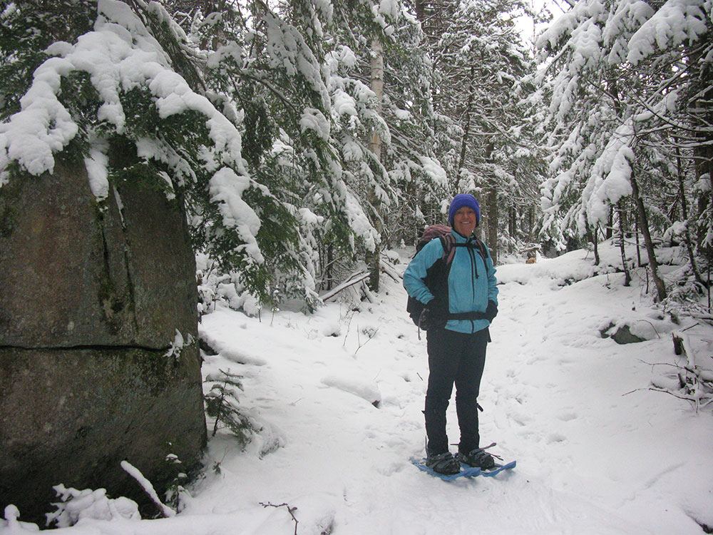 hiker on the trail in snowshoes in winter