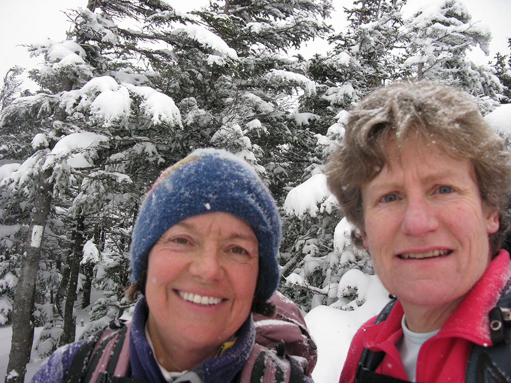 two hikers on the summit of North Kinsman in the White Mountains
