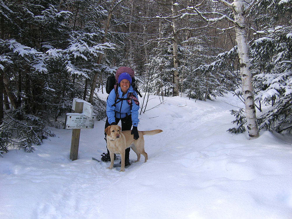hiker and lab at trailhead