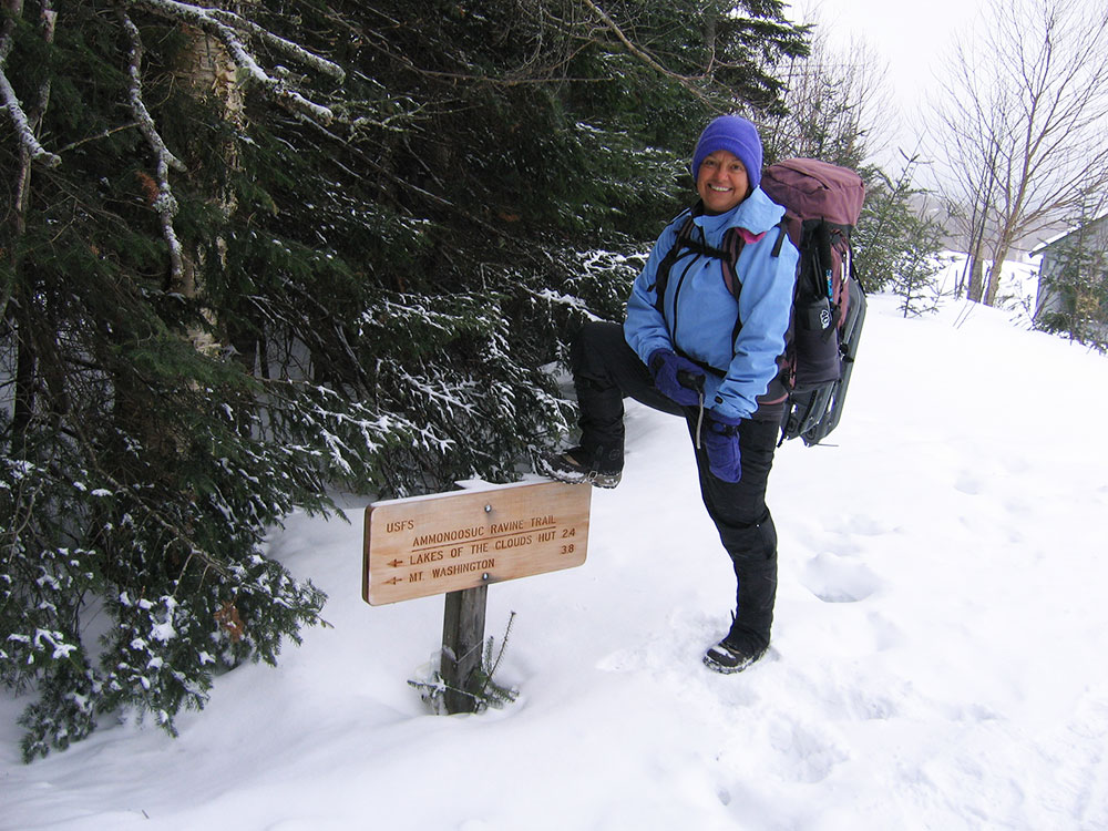 hiker with foot on trailhead sign - the snow is soo deep