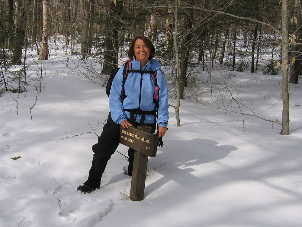 hiker at the trailhead sign