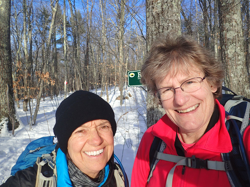 two hikers taking a selfie at the trailhead