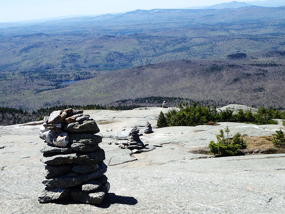view of cairns going into the distance on rock slab