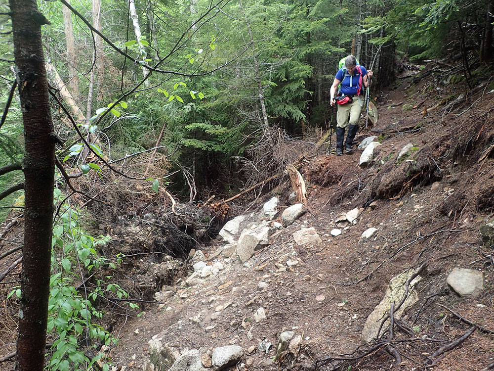 Pat hiker navigating eroded trail