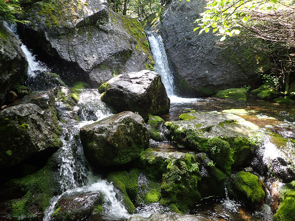waterfall flowing over boulders
