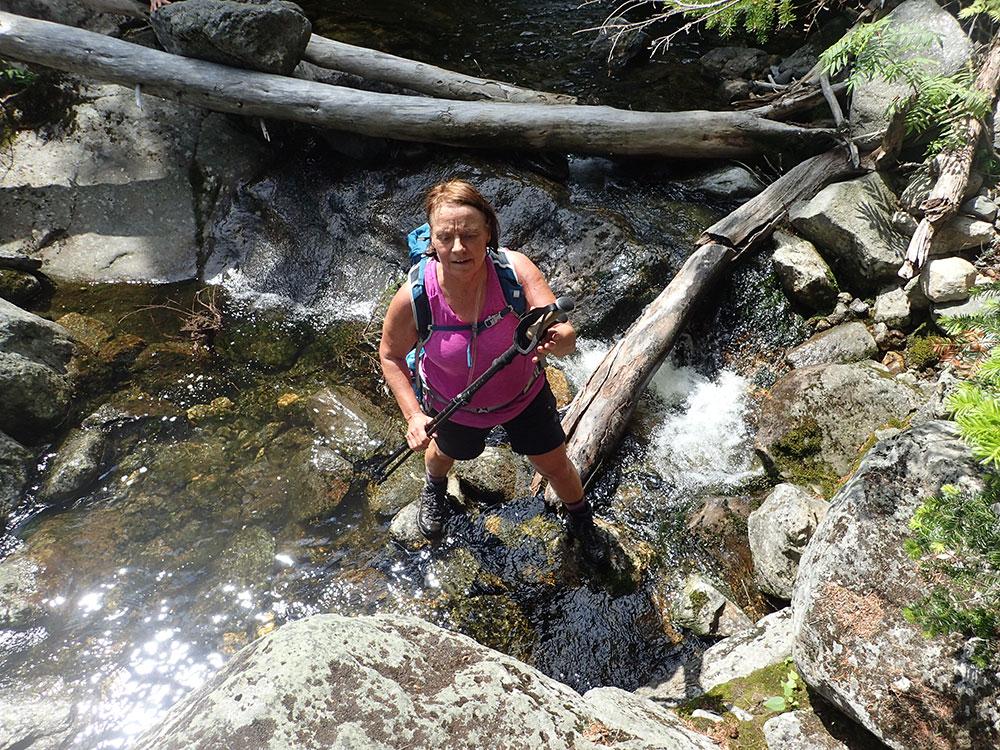 hiker crossing a stream seen from above