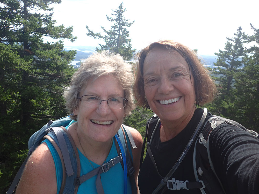 two hikers taking a selfie on the summit of Mt Percival