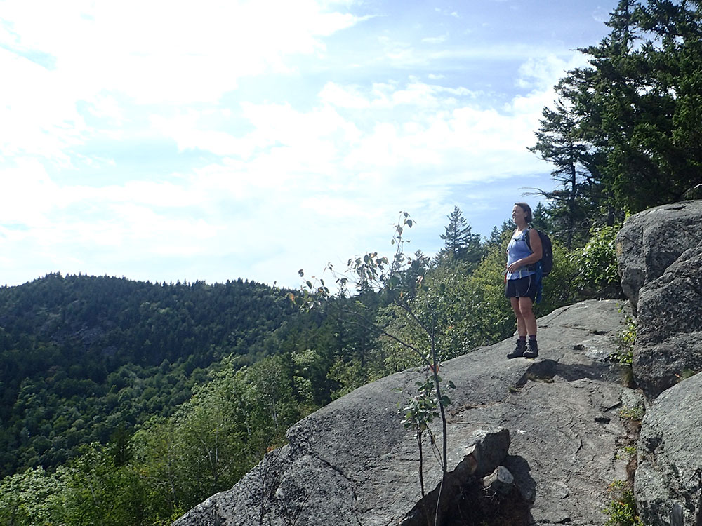 hiker standing on slab ledge