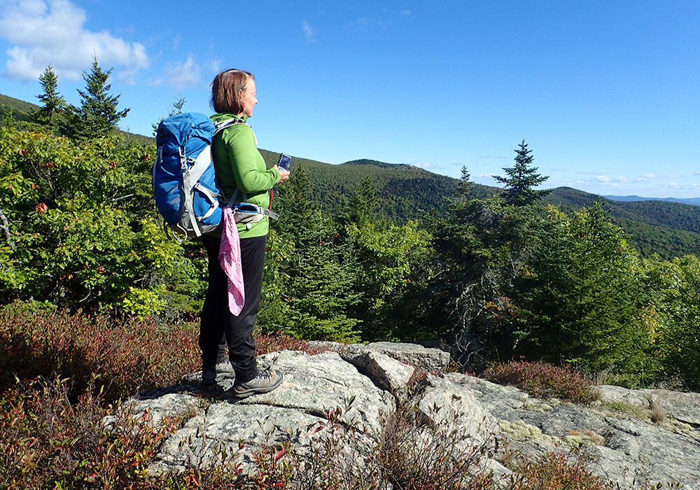 hiker enjoying the view of Lake Winnepesauke