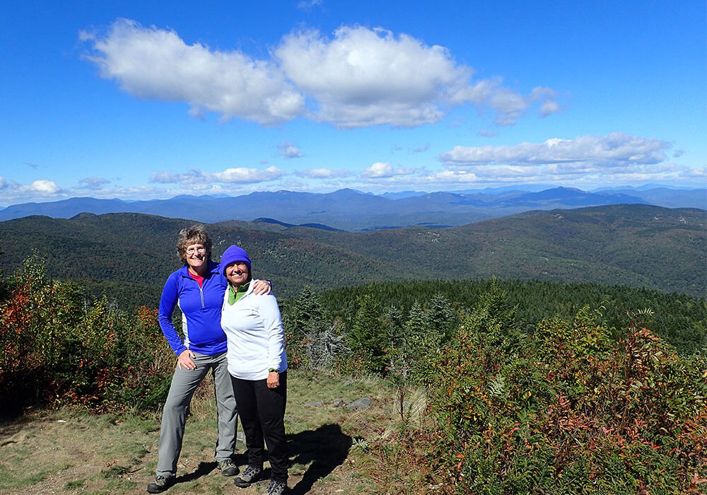 two hikers on the summit of Mt. Shaw looking north