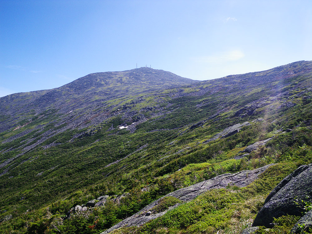 looking up into the sun at the summit antennas on Mt Washington
