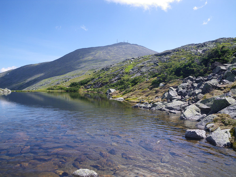Mt Washington summit in background and alpine tarn in foreground