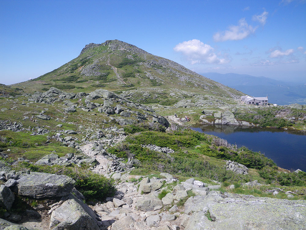 alpine lake in foreground and mountain in the background