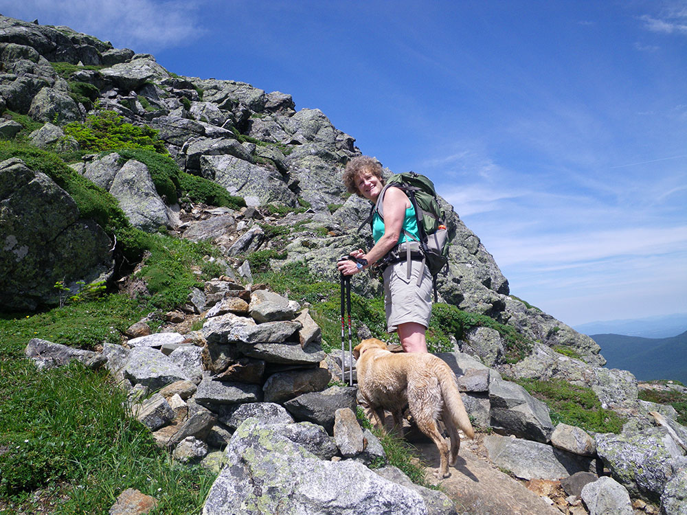 Pat and Dejah hiker weaving her way down a rocky trail above tree line