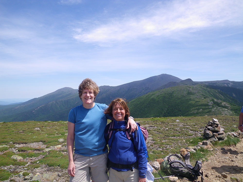 Pat and Nancy two hikers posing on the summit of a mountain above tree line