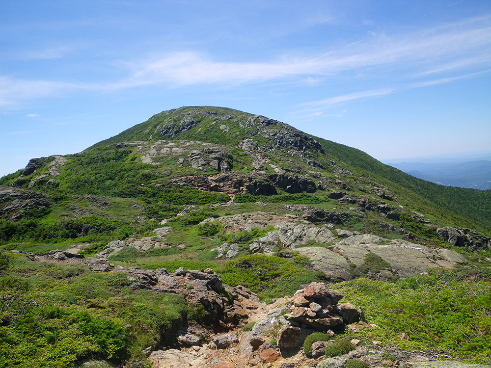 Mt. Eisenhower rock-lined trail above tree line looking toward the summit of a mountain