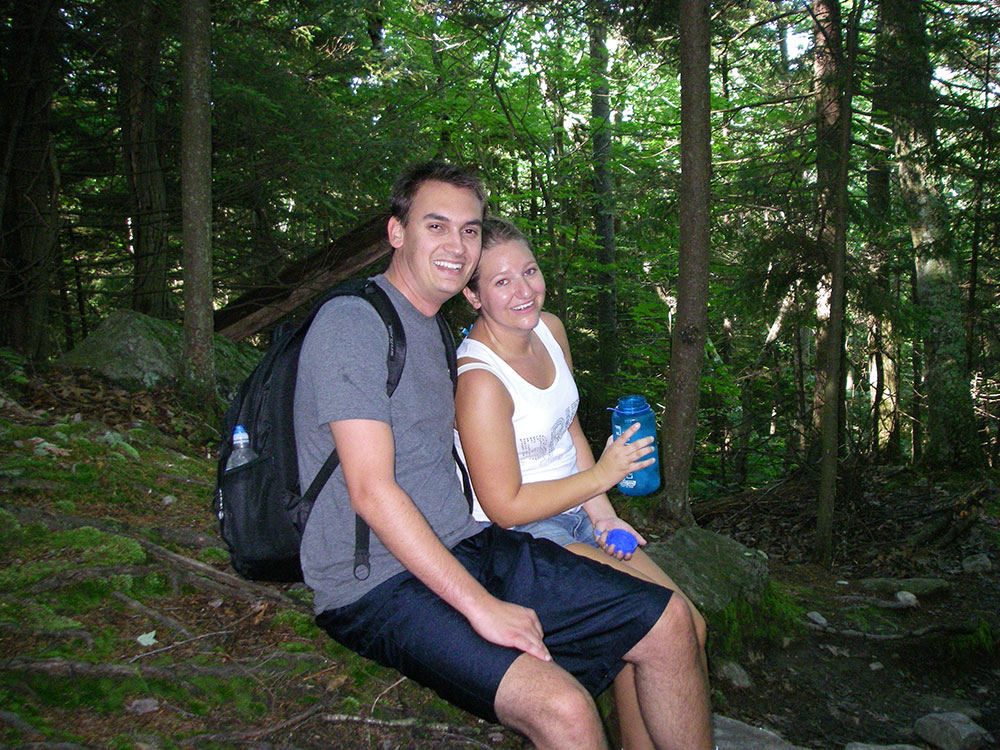 bride and groom resting on the trail