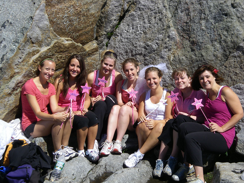 bride with her maids of honor on the summit of a mountain