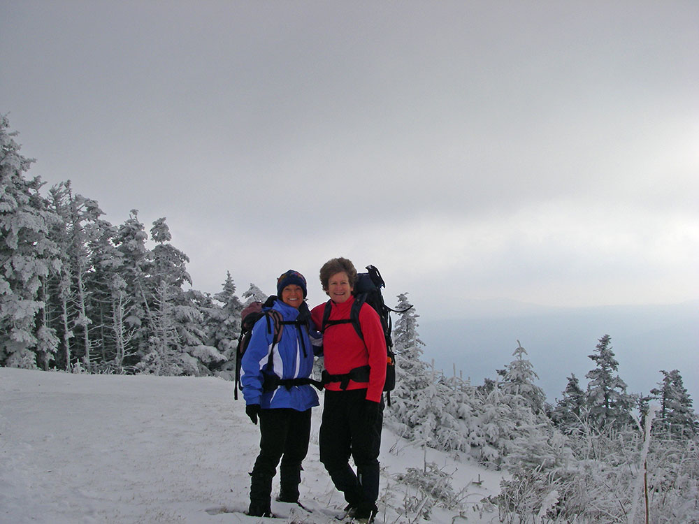 two hikers on the summit of Mt Equinox