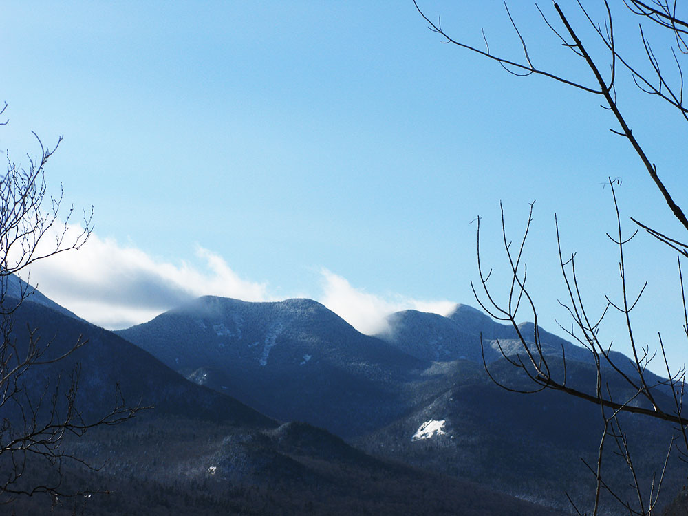 wind whipping clouds of distant mountain tops