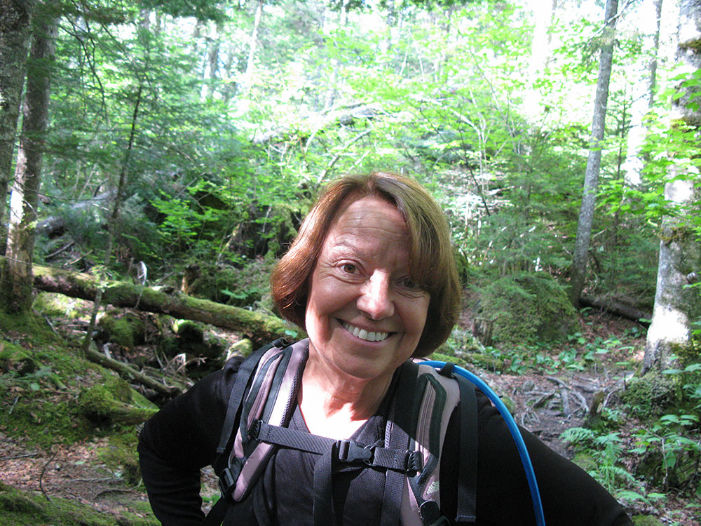 Nancy hiker on the trail smiling
