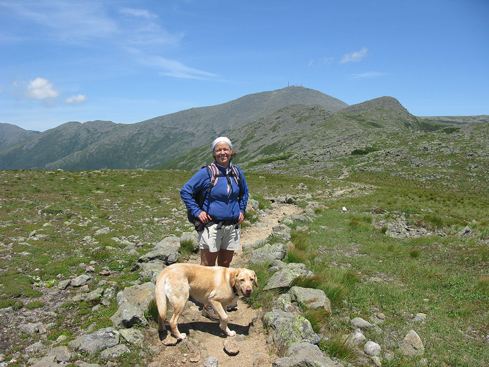 Nancy and Dejah hiker and yellow lab on the trail above tree line