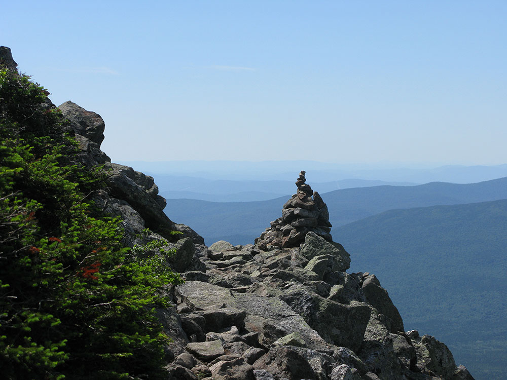 Fantastic View trail leading next to cairn and mountains in the distance