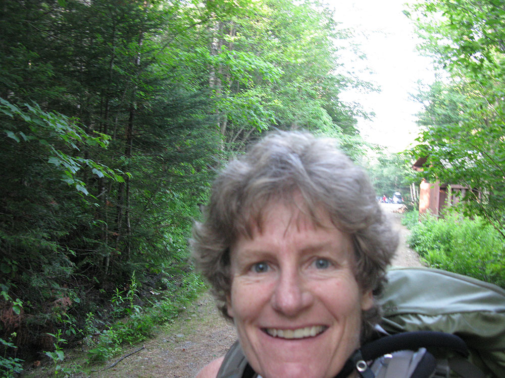 hiker taking a selfie as she starts her hike at the trailhead
