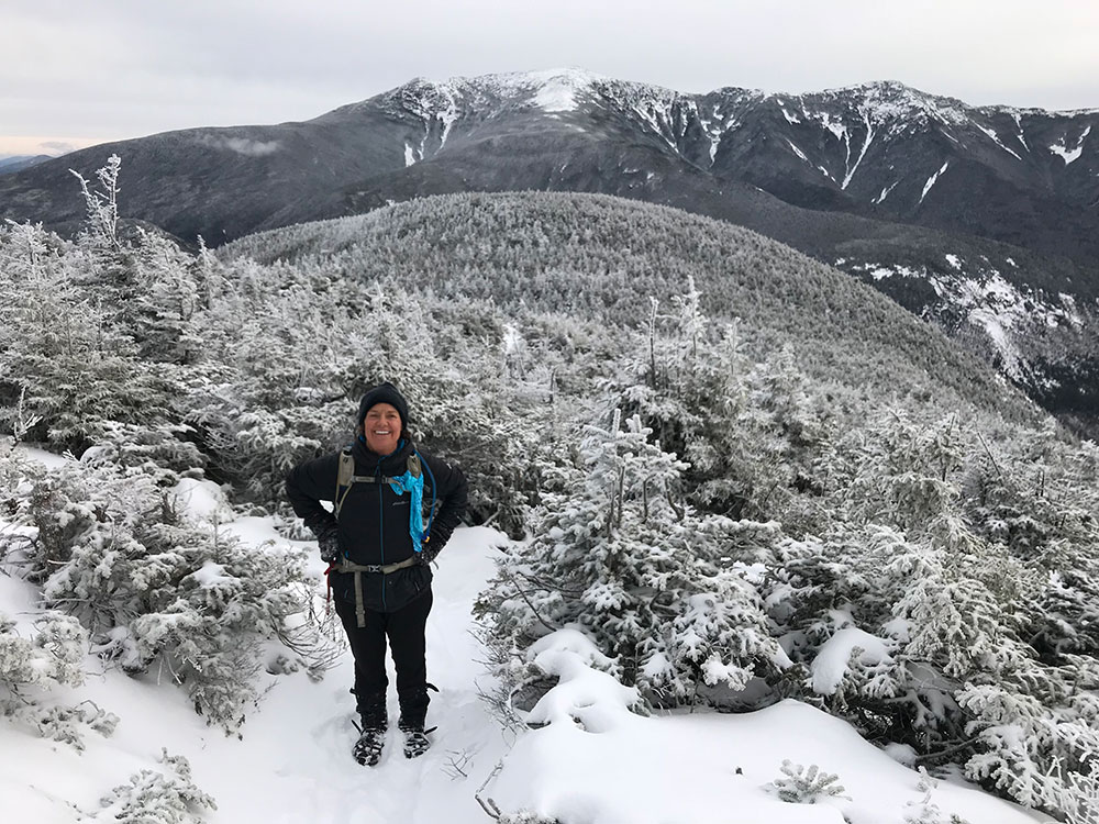 hiker climbing on snowy trail