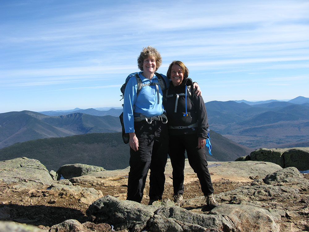 two hikers on the summit of Mt. Lincoln in NH