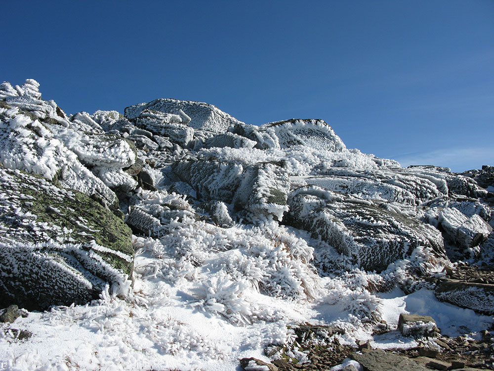 rime ice covering the north side of rocks