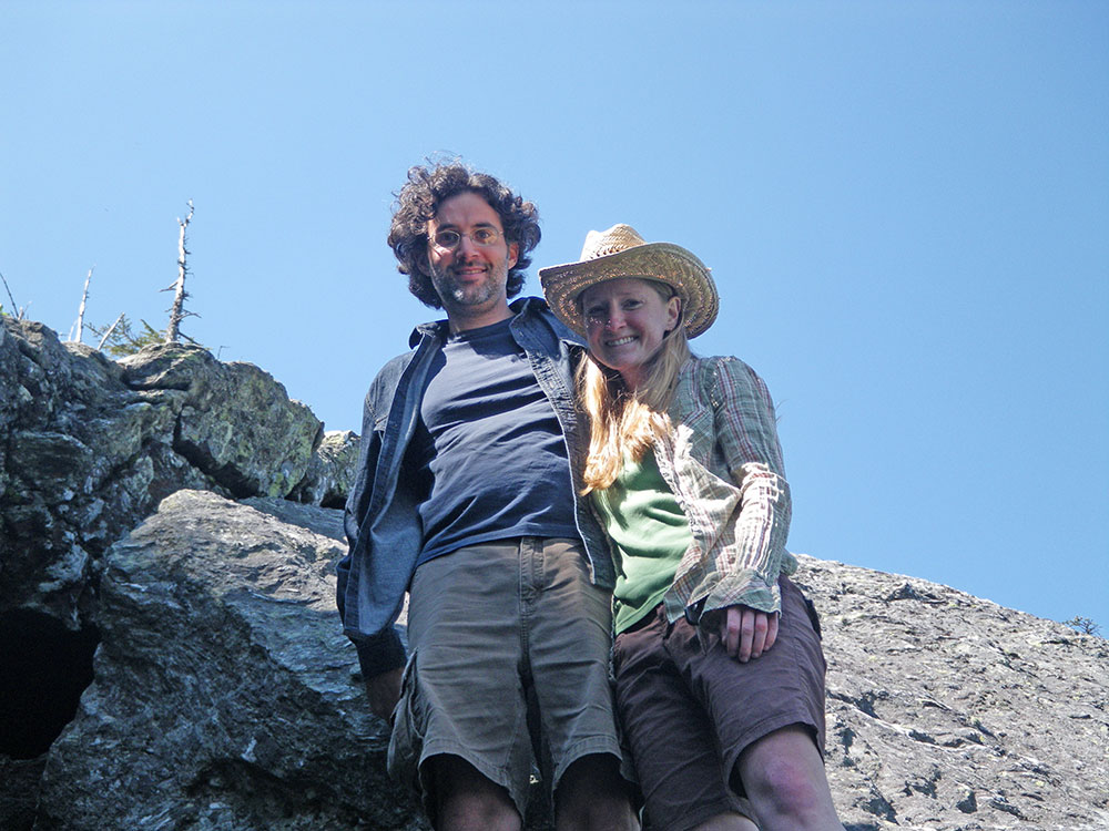 two hikers standing above the camera
