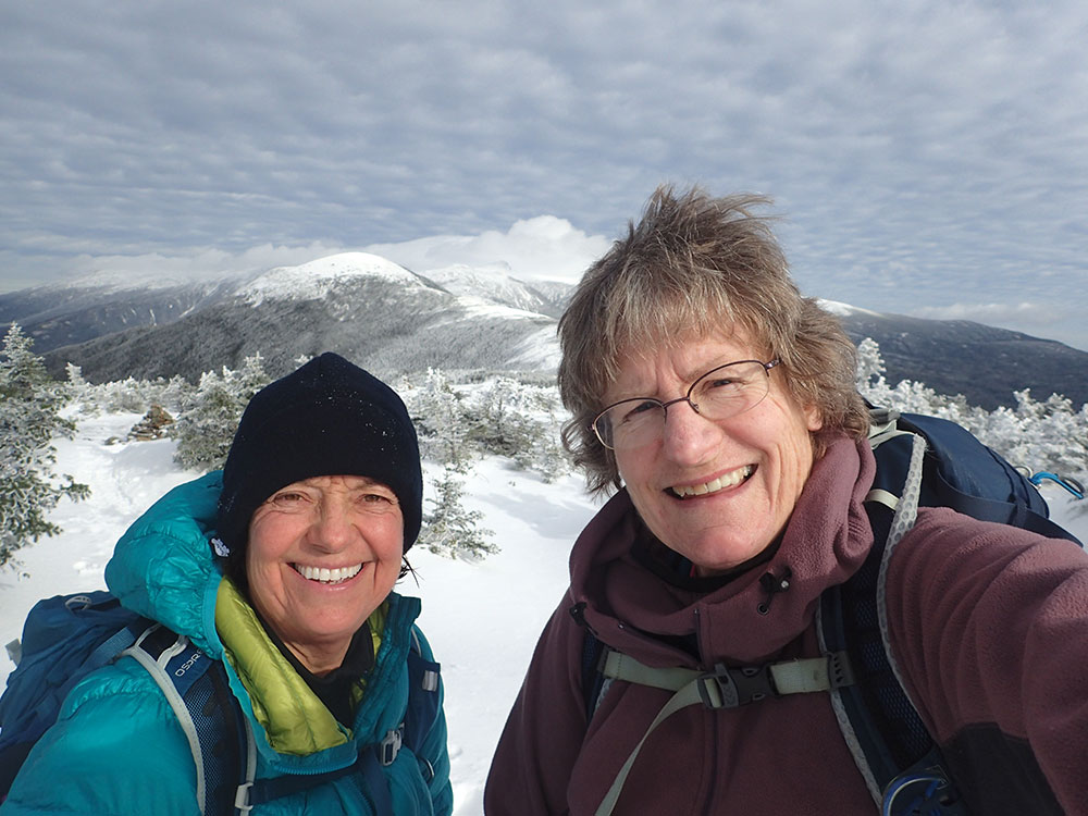 two hikers taking a selfie on the summit of Mt Pierce in NH