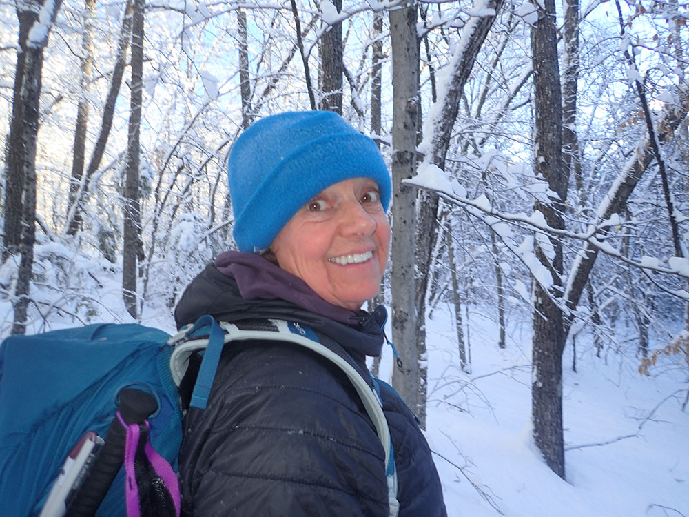 Nancy hiker on snowy winter trail