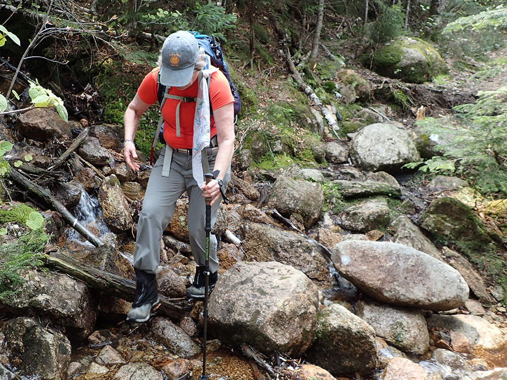 hiker tramping on rocky trail