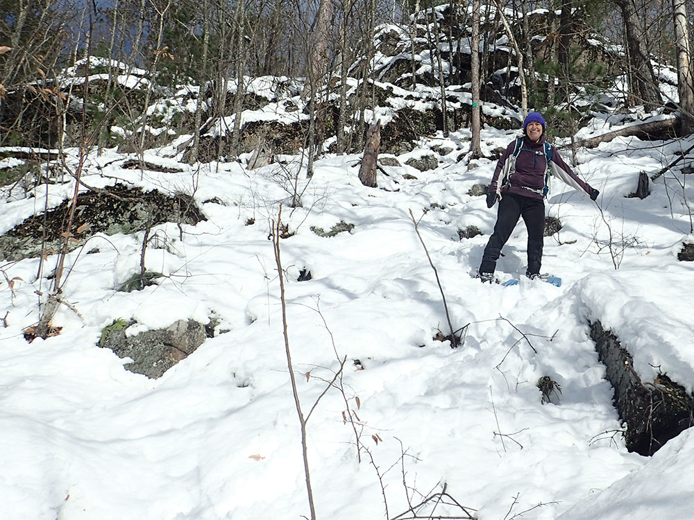 hiker walking on snowy trail